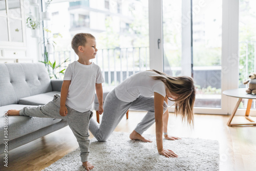 Mom with her son working out in the living room