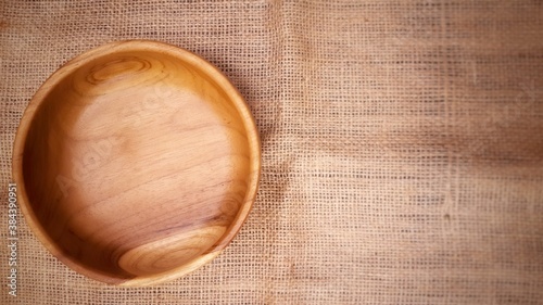 A natural wooden plate on a table photo