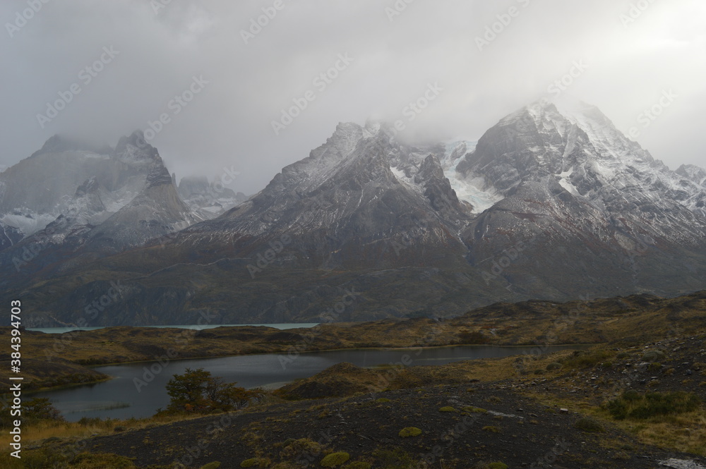 Fototapeta premium Hiking around the dramatic and windy mountain landscapes of Torres del Paine in Patagonia, Chile