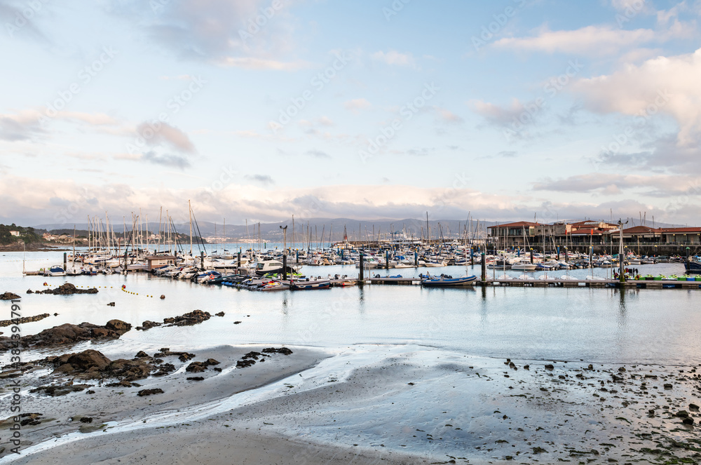 Panorama view of the yacht club of Sanxenxo full of small sailing boats on a cloudy Summer day, Pontevedra, Spain. Panorama view of the yacht club of Sanxenxo full of small sailing boats on a cloudy Summer day, Pontevedra, Spain.
