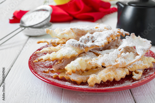 Brushwood - crispy deep fried cookies in powdered sugar with tea and jam. A traditional treat at European festivals.