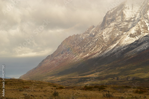 Hiking around the dramatic and windy mountain landscapes of Torres del Paine in Patagonia, Chile photo