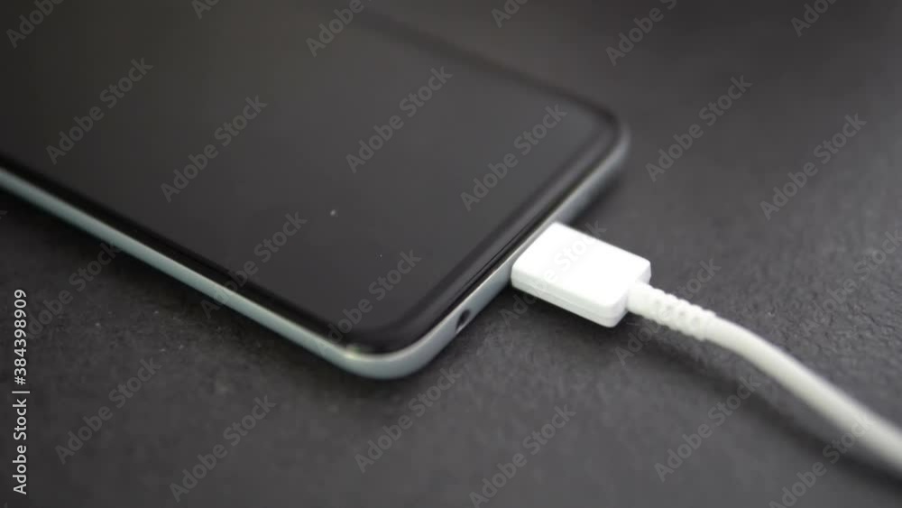 Connected Smart Phone Charging on White USB C cable Connected Smart Phone Charging on White USB C cable