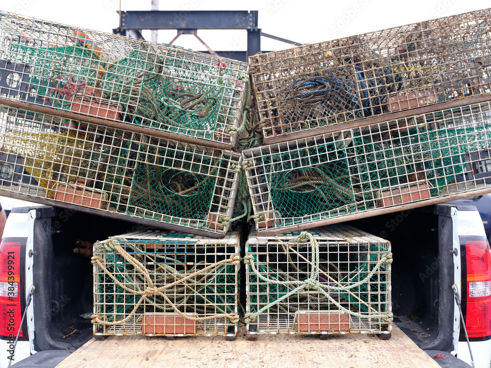 Lobster Traps sitting on the back of a pickup truck waiting to be unloaded on a Working Maine Dock