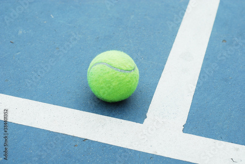 Tennis ball on concrete blue field with white line © yoki5270