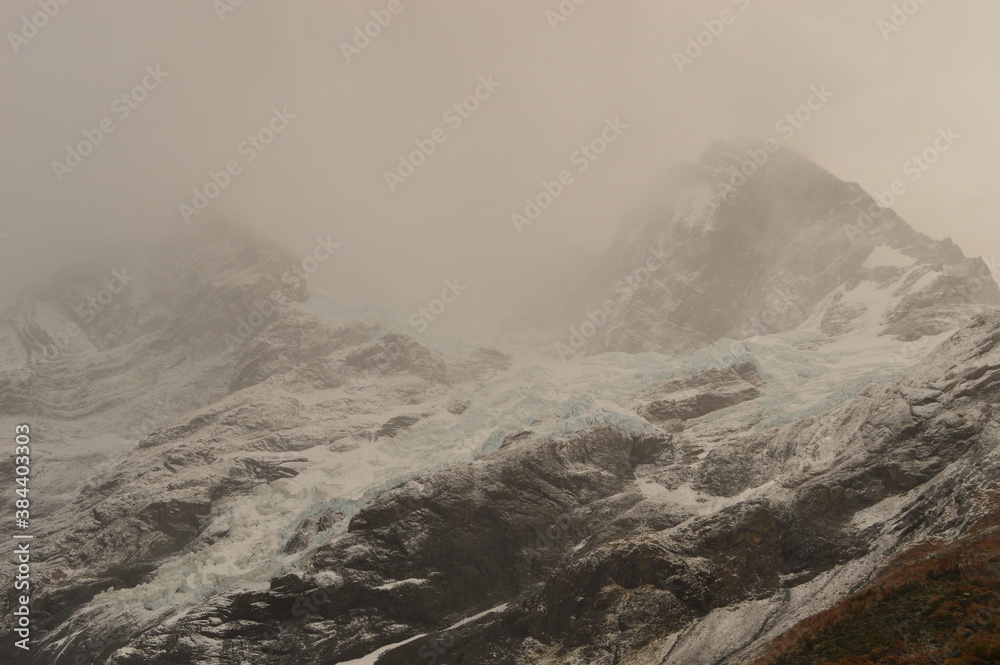 Obraz premium Hiking in the windy and snowy mountains of the Torres del Paine National Park in Patagonia, Chile