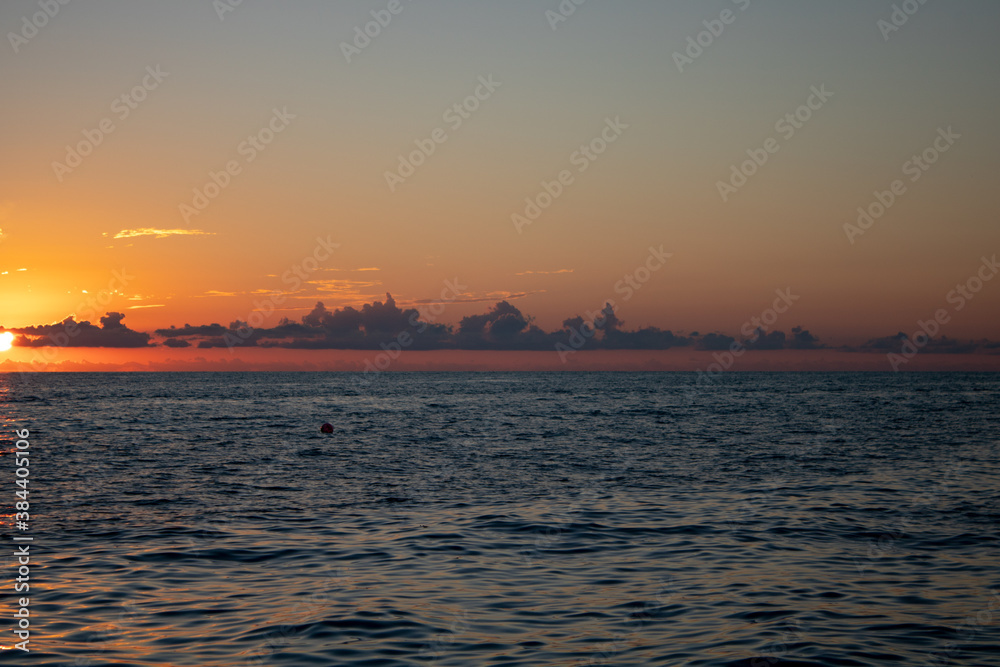 Wonderful panoramic view of the sunset over the Sochi sea with dark red clouds.