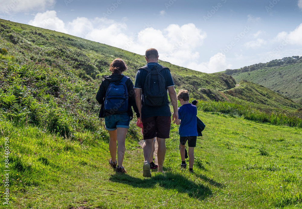 
The backview of a family walking along the coastal path at Hartland, North Devon..