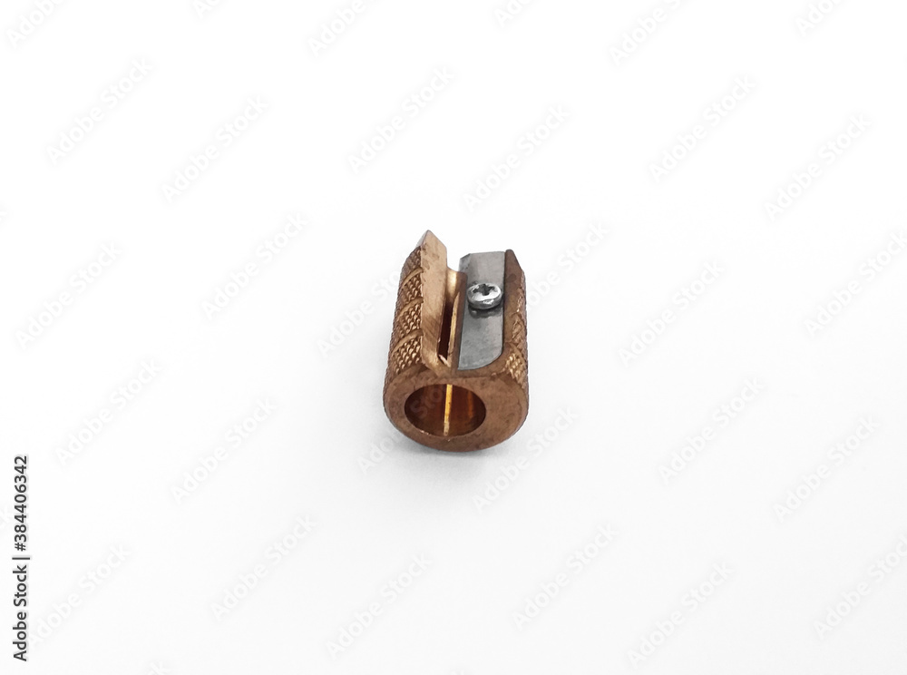 Brass pencil sharpener with a single hole isolated on white background. Close up. Pencil sharpener made of brass. Drawing, fine arts and office supplies. Brass pencil sharpener with a single hole isolated on white background. Close up. Pencil sharpener made of brass. Drawing, fine arts and office supplies.