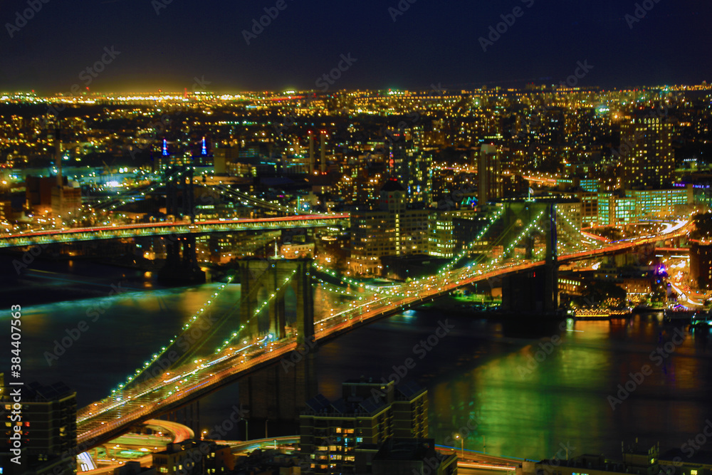 Brooklyn Bridge with lower Manhattan skyline in New York City at night, USA