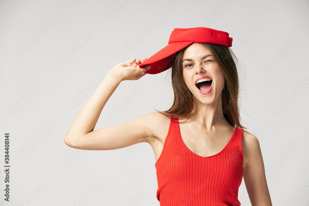 Cheerful woman open mouth emotions Red cap tank top cropped view Cheerful woman open mouth emotions Red cap tank top cropped view