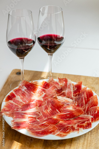 Plate of Iberian ham and glasses of Spanish red wine