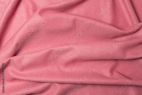 Beautiful draped wool and cotton fabric for background. Pink fabric for decoration with folds.