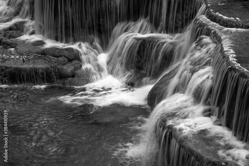 Huay Maekamin Waterfall in Kanchanaburi, Thailand; black and white monochrome photo by long exposure with slow speed shutter. photo