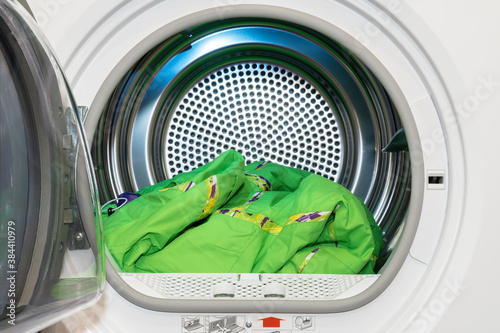 Clothes dryer with washed and dried outdoor clothes inside.