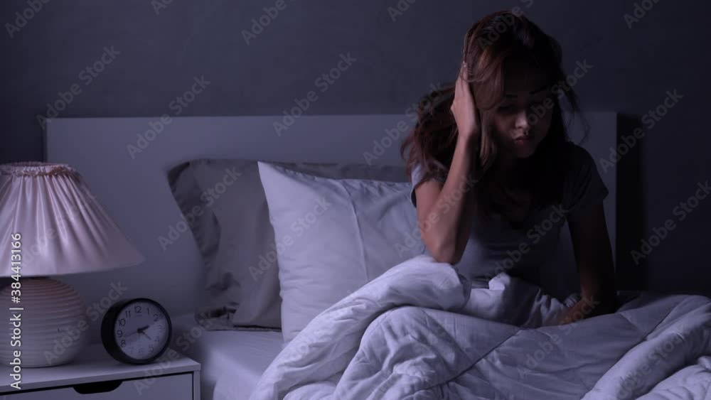 Depressed young Asian woman cannot sleep from insomnia. Depressed woman suffering from insomnia lying in bed. Depressed young Asian woman cannot sleep from insomnia. Depressed woman suffering from insomnia lying in bed.