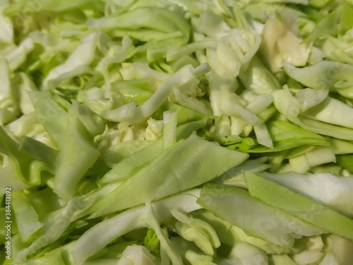 Sliced Cabbage background. Fresh cabbage from farm field. Close up macro view of green cabbages. Vegetarian food concept. slide white cabbage closeup ready to cooking. Popular Green vegetable. 