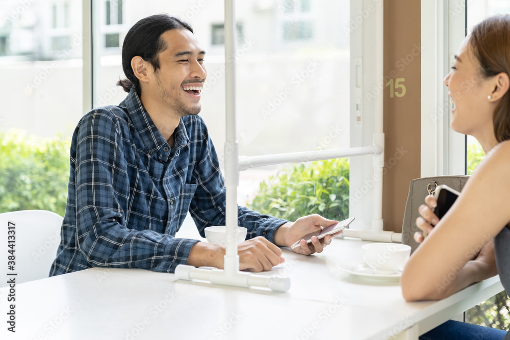 Asian couple eating out at new normal restaurant Asian couple eating out at new normal restaurant