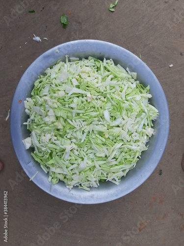 Sliced of Cabbage in the bowl. Fresh cabbage from farm field. Close up macro view of green cabbages. Vegetarian food concept. slide white cabbage closeup ready to cooking. Popular Green vegetable. 
