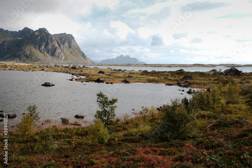 Uninhabited Lofoten Islands during Covid-19 pandemic situation in autumn. No tourists and very quiet and peaceful fall mood and beautiful colors. Ocean view and spectacular mountains at the back. 