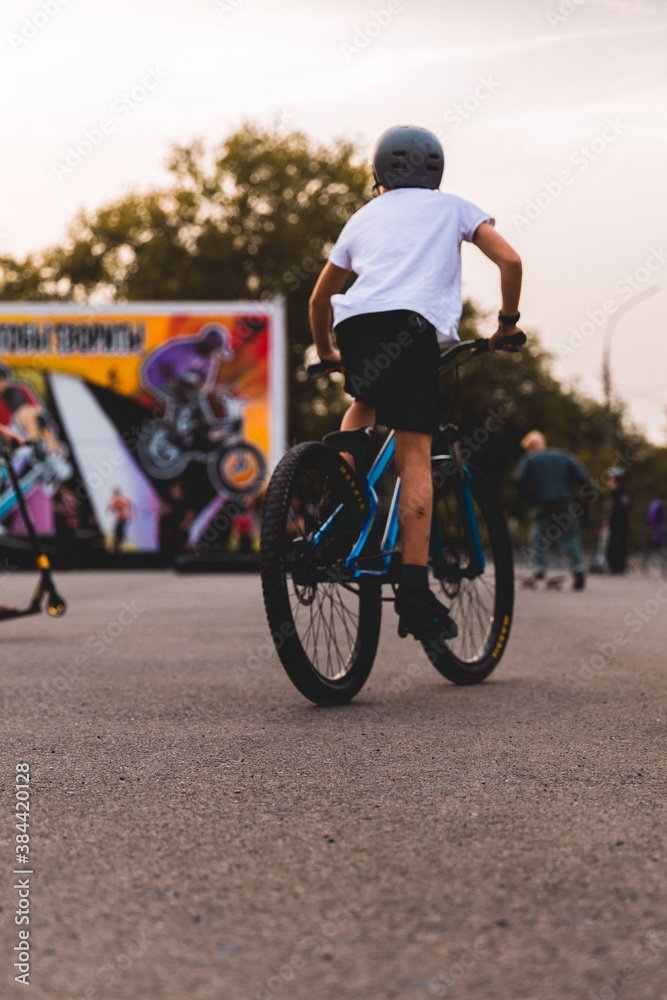 Fototapeta premium Teenage boy standing by bmx bike at skatepark