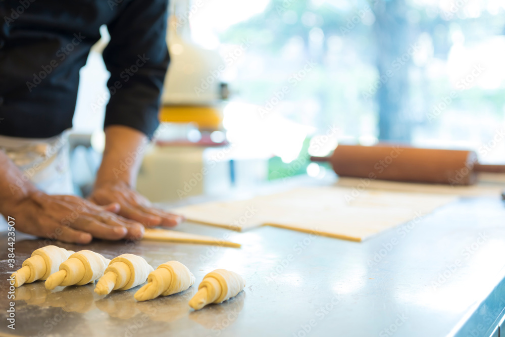 Hands baking dough with rolling pin on wooden table 
Hand, Cooking, Dough, Bread, Bakery,Croissant 