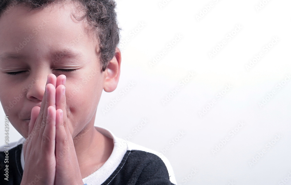 boy praying to God with hands held together with closed eyes on white background stock photo boy praying to God with hands held together with closed eyes on white background stock photo
