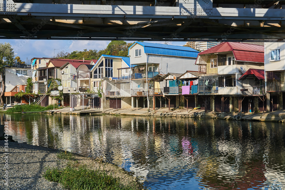 the bank of the Dagomys river is built up with small cottages with garages for boats the bank of the Dagomys river is built up with small cottages with garages for boats
