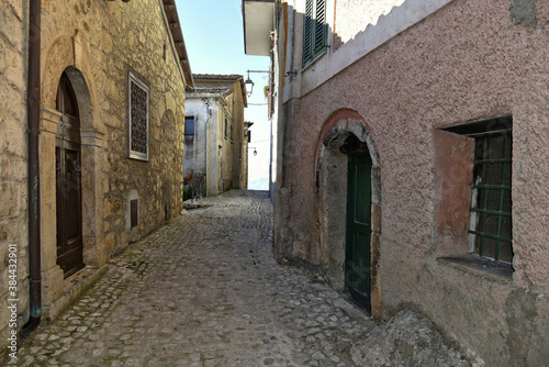 Fototapeta Naklejka Na Ścianę i Meble -  A narrow street between the old houses of Fumone, a medieval village in the province of Frosinone, Italy.