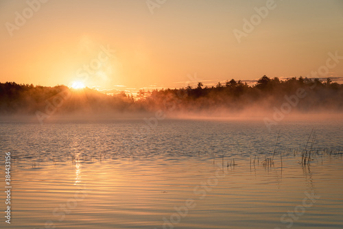 Morning fog and sunrise at Lower Togue Pond, in Baxter State Park, Maine photo