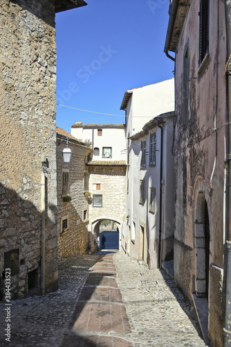 A narrow street between the old houses of Fumone, a medieval village in the province of Frosinone, Italy.