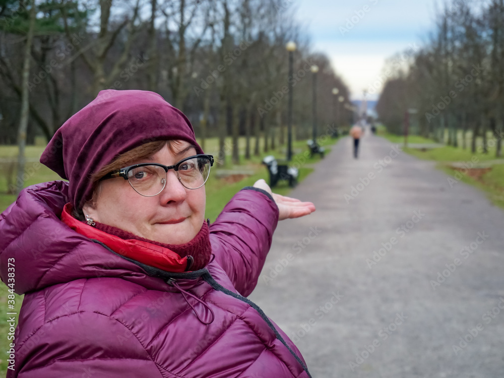 Mature plump woman in glasses resting in a city Park Mature plump woman in glasses resting in a city Park