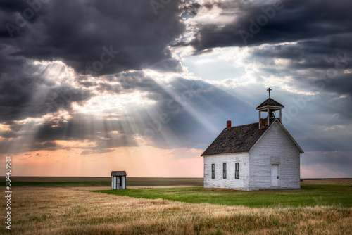 An old abandoned Church in the countryside at sunset. The scene is very dramatic and spiritual. 