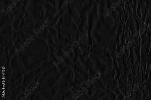 Black vintage and old looking crumpled paper background. Retro cardboard texture. Grunge paper for drawing. Ancient book page. Present wrapping. © artistmef