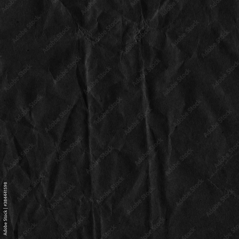 Fototapeta premium Black vintage and old looking crumpled paper background. Retro cardboard texture. Grunge paper for drawing. Ancient book page. Present wrapping.
