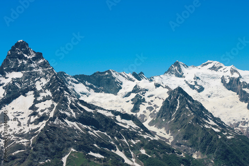 Caucasus Mountains Under Snow And Clear Blue Sky