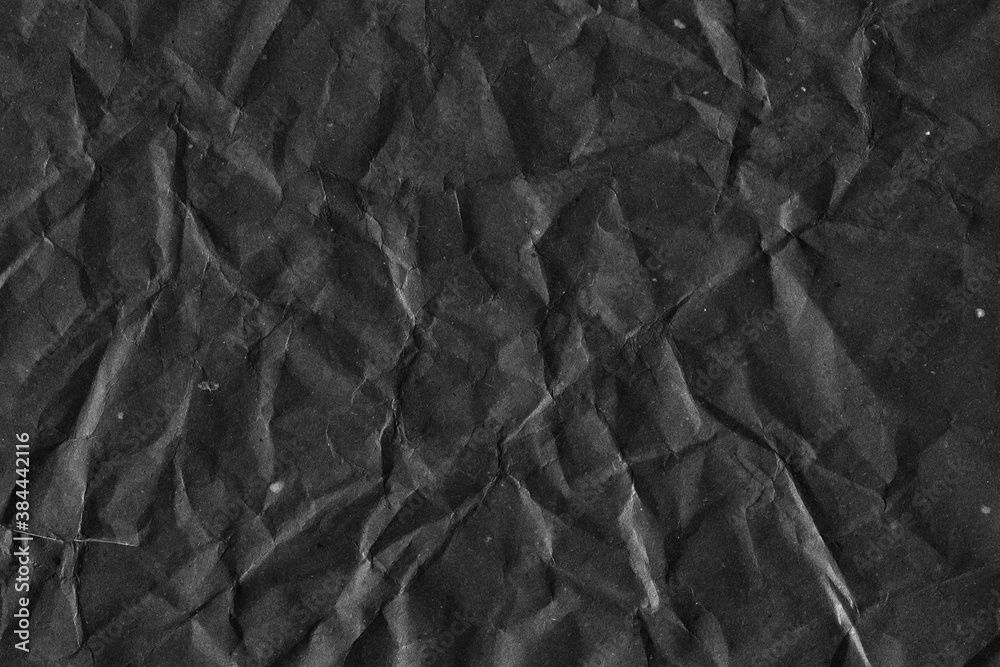 Fototapeta premium Black vintage and old looking crumpled paper background. Retro cardboard texture. Grunge paper for drawing. Ancient book page. Present wrapping.