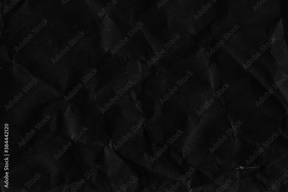 Fototapeta premium Black vintage and old looking crumpled paper background. Retro cardboard texture. Grunge paper for drawing. Ancient book page. Present wrapping.