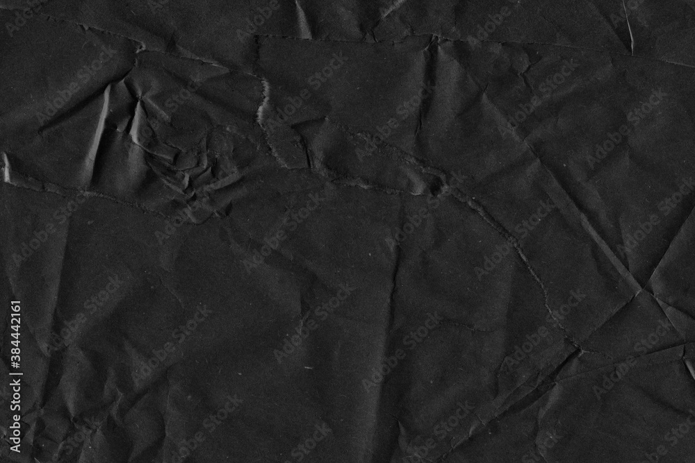 Fototapeta premium Black vintage and old looking crumpled paper background. Retro cardboard texture. Grunge paper for drawing. Ancient book page. Present wrapping.