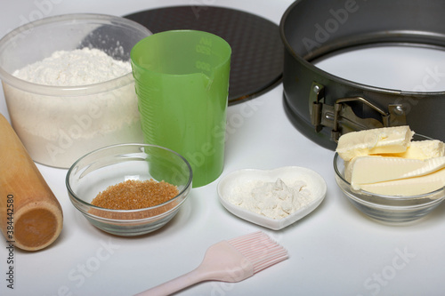 Butter on a kitchen scale. Sugar and flour in containers, collapsible baking dish. Levington cake, stages of preparation.