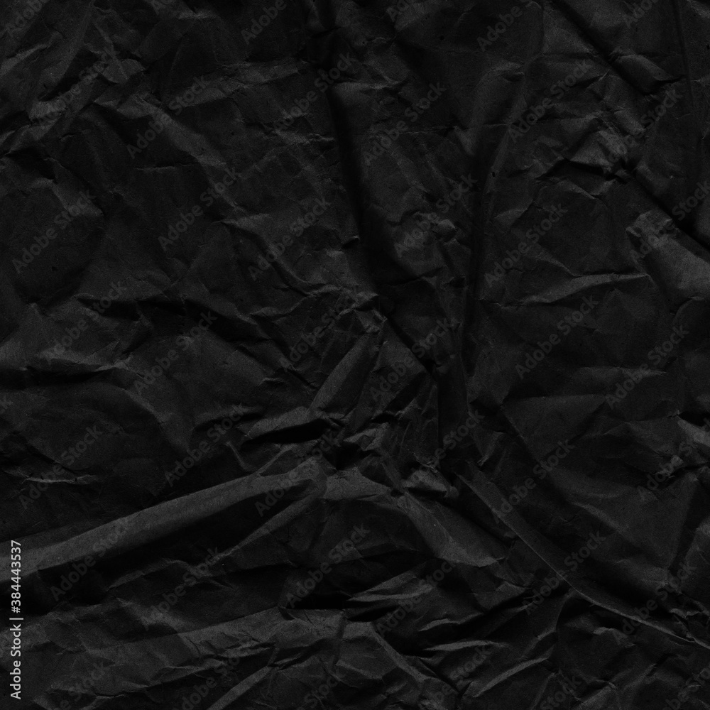 Black vintage and old looking crumpled paper background. Retro cardboard texture. Grunge paper for drawing. Ancient book page. Present wrapping.