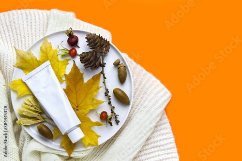 Organic autumn face or body cream on orange background with copy space. Skin care. skin food
