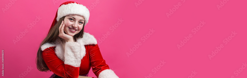 Beautiful young woman in Santa Claus costume against the red background. Beautiful young woman in Santa Claus costume against the red background.