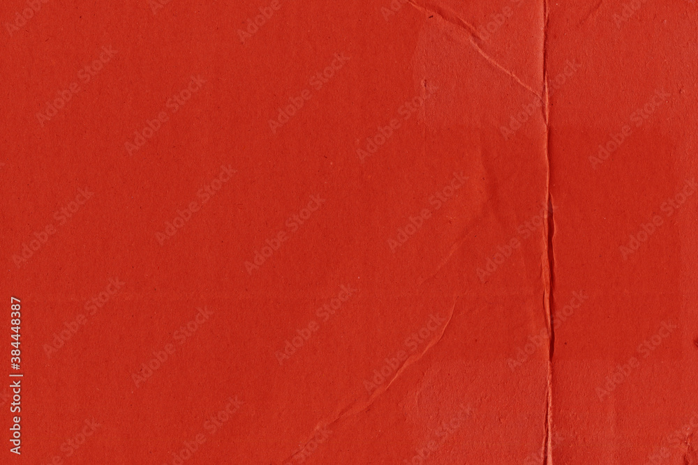 Fototapeta premium A red vintage rough sheet of carton. Recycled environmentally friendly cardboard paper texture. Simple and bright minimalist papercraft background.