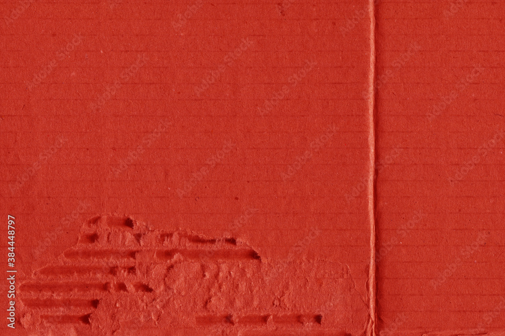 Fototapeta premium A red vintage rough sheet of carton. Recycled environmentally friendly cardboard paper texture. Simple and bright minimalist papercraft background. 