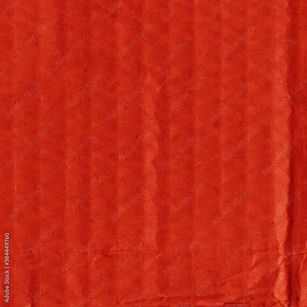 Fototapeta premium A red vintage rough sheet of carton. Recycled environmentally friendly cardboard paper texture. Simple and bright minimalist papercraft background. 