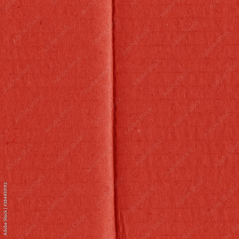 Fototapeta premium A red vintage rough sheet of carton. Recycled environmentally friendly cardboard paper texture. Simple and bright minimalist papercraft background. 
