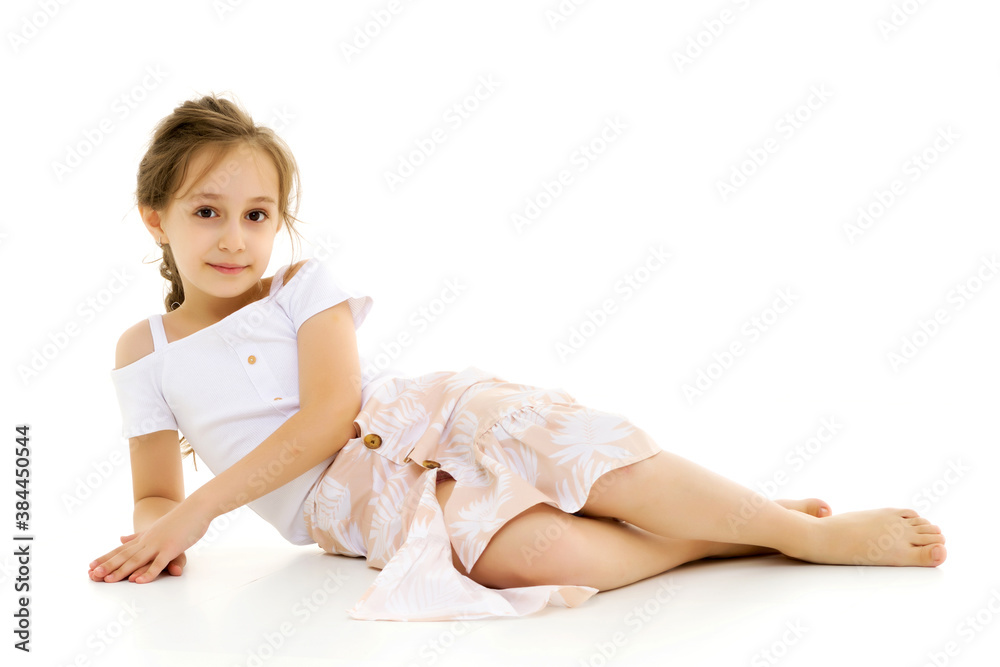 Beautiful Preteen Girl Lying on the Floor Against White Background Beautiful Preteen Girl Lying on the Floor Against White Background