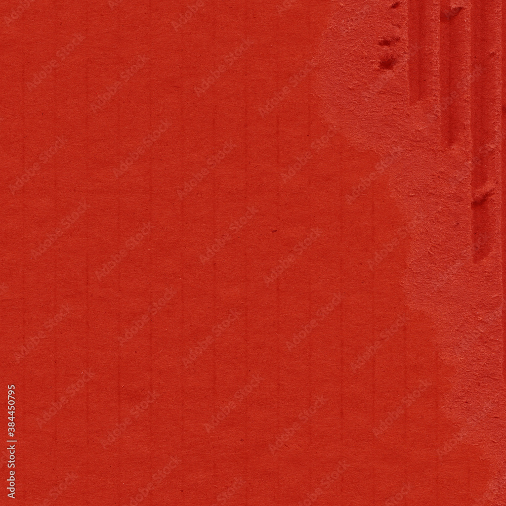 Fototapeta premium A red vintage rough sheet of carton. Recycled environmentally friendly cardboard paper texture. Simple and bright minimalist papercraft background.