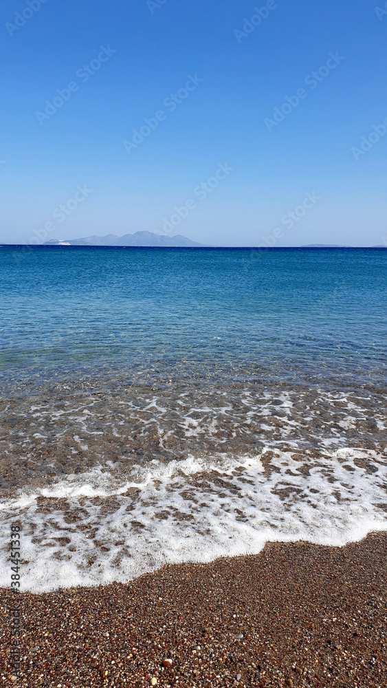 Blue Aegean sea and beach background. Aqua sea water surface. Sea surface view. Blue Aegean sea and beach background. Aqua sea water surface. Sea surface view.